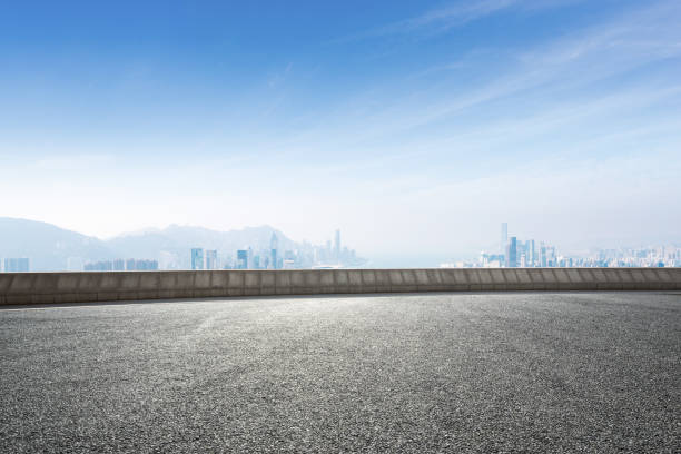 istock empty asphalt road with cityscape of modern city 897430176