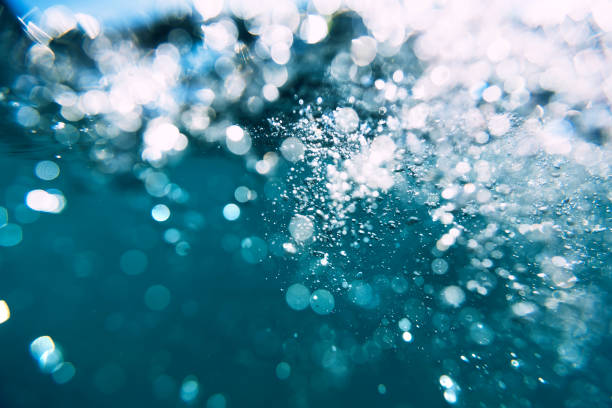 istock Underwater air bubbles and wave in sea. Water texture 897435122