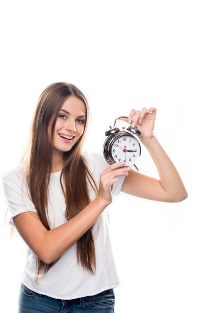 istock Girl holding alarm clock 897436084