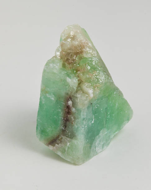 Ore green calcite on white background. Calcite is a carbonate mineral and the most stable polymorph of calcium carbonate (CaCO3). The Mohs scale of mineral hardness, based on scratch hardness comparison, defines value 3 as "calcite". calcite stock pictures, royalty-free photos & images