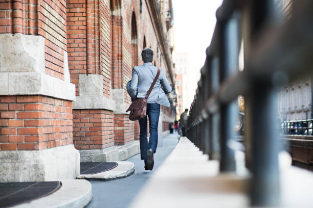 istock Mature businessman walking in a city. 897447652