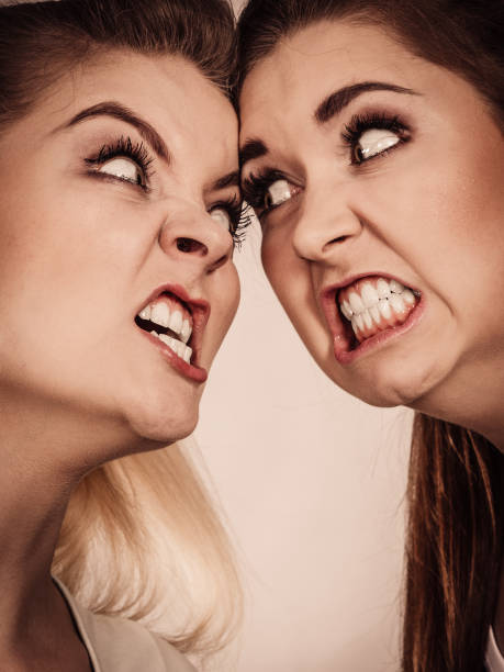 istock Two agressive women having argue fight 897450418