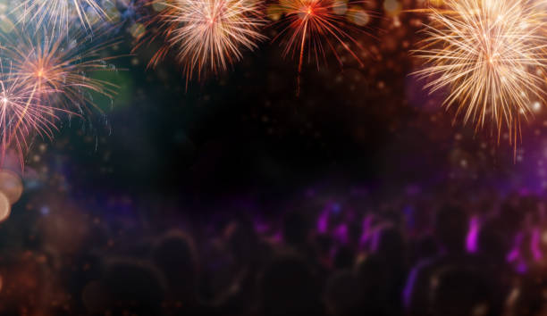 istock Abstract colored firework background with people silhouettes, free space for text. 897471242