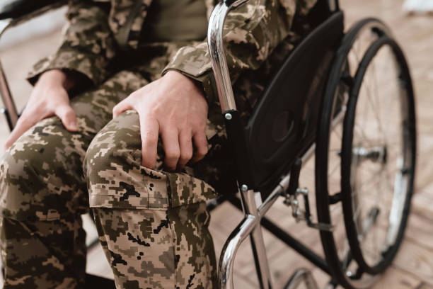 veteran in wheelchair returned from army. close-up photo veteran in a wheelchair. - physical impairment wheelchair disabled accessibility imagens e fotografias de stock