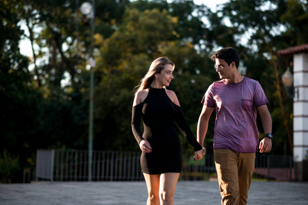 istock Attractive couple walking through the town square 897486826