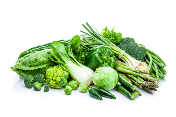 istock Healthy fresh green vegetables heap isolated on white background 897487318