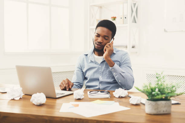 istock Young black businessman talking on mobile phone 897488026