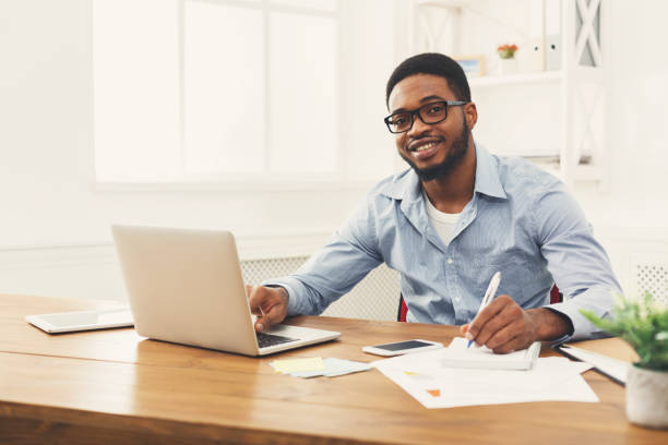 istock Young black businessman working with laptop 897490164