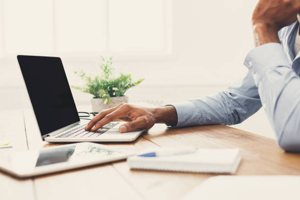istock African-american businessman typing on laptop 897490212