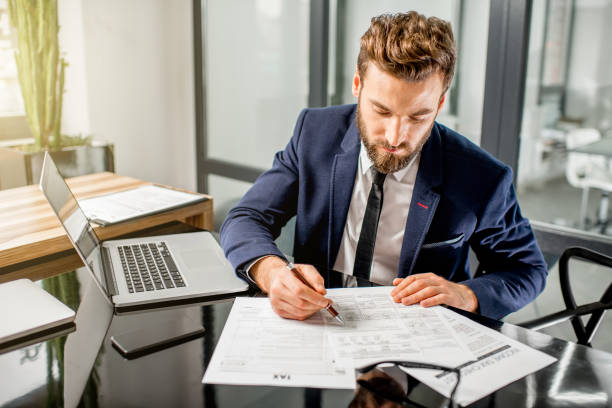 tax manager working at the office - occupation office bill finance imagens e fotografias de stock