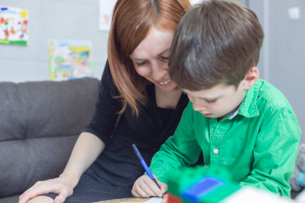 istock Happy mother and son colouring together 897498354