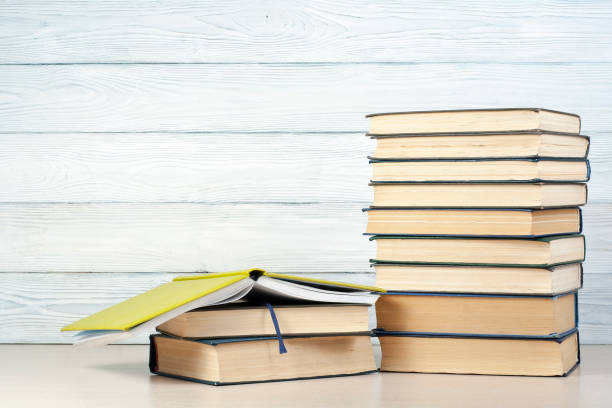 istock Open book, hardback books on wooden table. Education background. Back to school. Copy space for text. 897509160