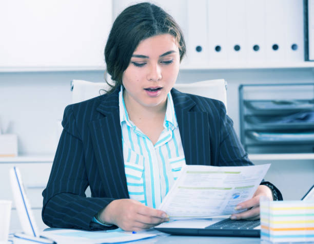 istock Young businesswoman is reading documents about the transaction 897509542