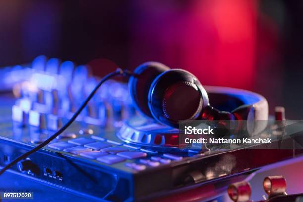 The Dj Console Cd Mp4 Deejay Mixing Desk Ibiza House Music Party In Nightclub With Colored Disco Lights Stock Photo - Download Image Now