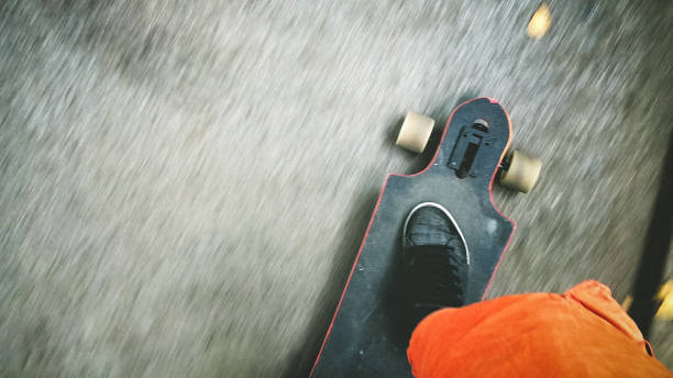 istock Longboarder driving on the street 897515152