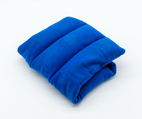 Blue microwave heating pad isolated on white background. Cold and hot wrap for shoulder,  neck, back, and body pain relief therapy.