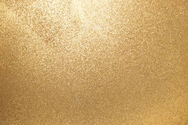 Photo of Closed up of metallic gold glitter textured background