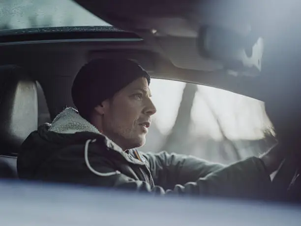 Photo of Man out with his car in winter nature landscape