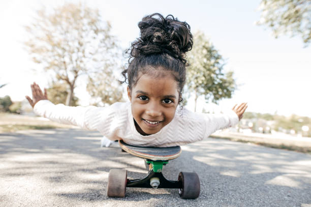 istock Happy skateboarding girl 897525384