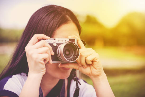 istock Female photographer with professional digital camera 897525486