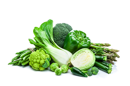 Front view of healthy fresh green vegetables heap isolated on white background. Vegetables included in the composition are lettuce, bell pepper, cucumber, broccoli, green bean, cabbage and asparagus. Predominant color is green. DSRL studio photo taken with Canon EOS 5D Mk II and Canon EF 70-200mm f/2.8L IS II USM Telephoto Zoom Lens
