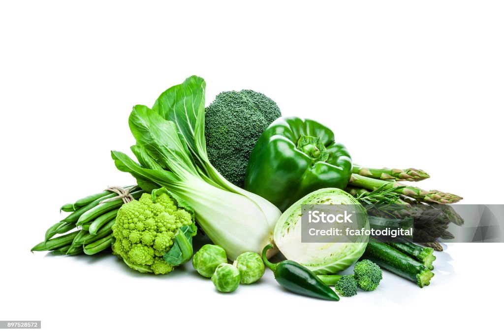 Healthy fresh green vegetables heap isolated on white background Front view of healthy fresh green vegetables heap isolated on white background. Vegetables included in the composition are lettuce, bell pepper, cucumber, broccoli, green bean, cabbage and asparagus. Predominant color is green. DSRL studio photo taken with Canon EOS 5D Mk II and Canon EF 70-200mm f/2.8L IS II USM Telephoto Zoom Lens Vegetable Stock Photo