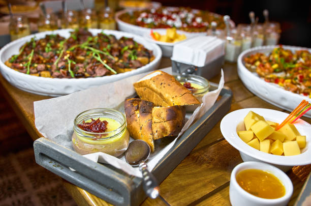 istock Buffet table with Bruschetta, Appetizers and different sauces. with hummus, beef, pate, avocado, tomatoes. on a wooden rustic table. 897546774