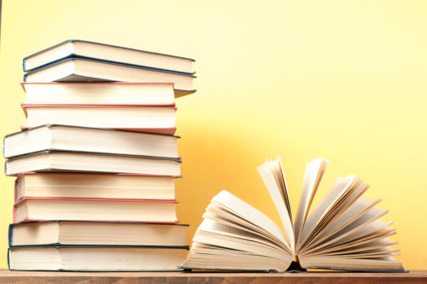 istock Open book, hardback books on wooden table. Education background. Back to school. Copy space for text. 897558298