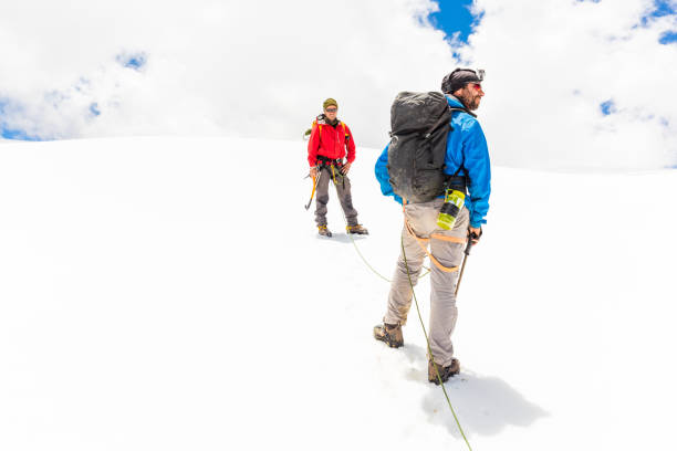 istock Two alpinists friends walking climbing ice glacier mountain Andes Peru 897560932