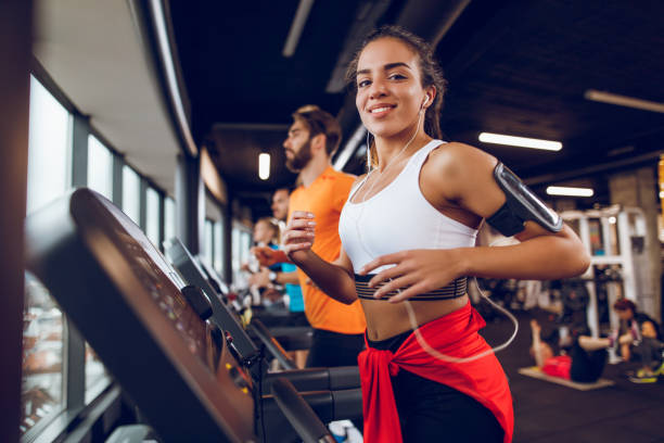 istock Young woman exercising on treadmill 897561624