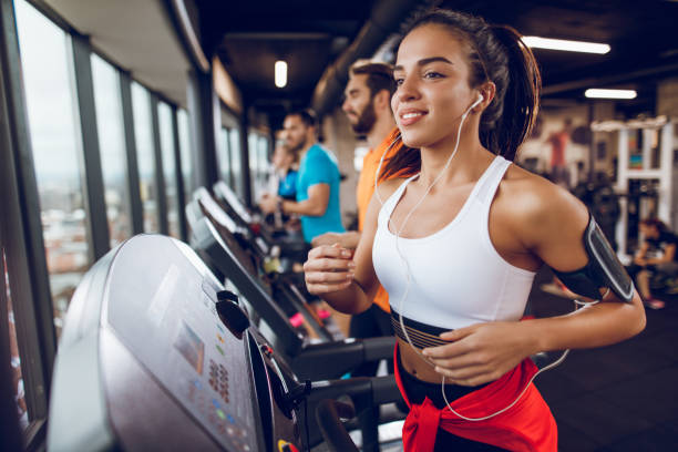 istock Young woman exercising on treadmill 897564508