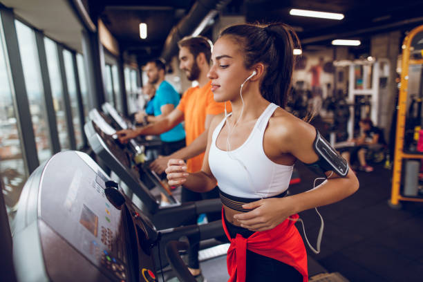 istock Young woman exercising on treadmill 897564768