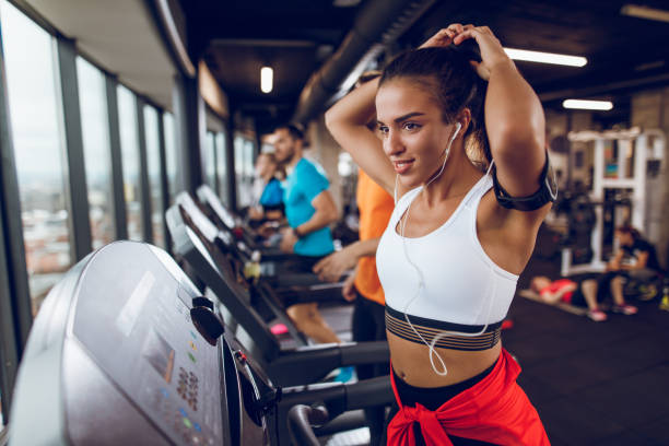 istock Young woman exercising on treadmill 897573098