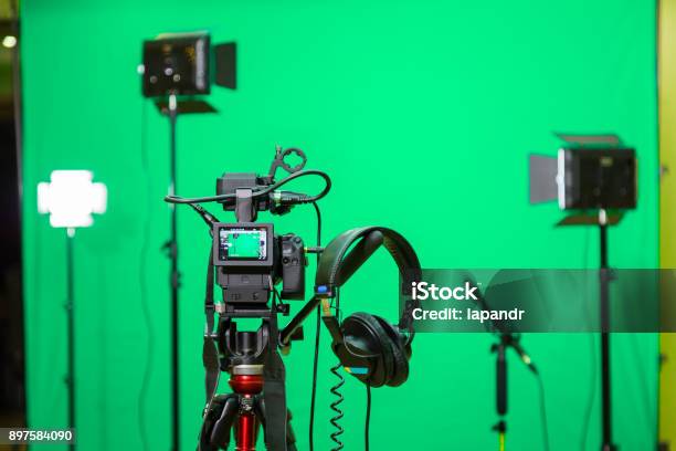 The Camera On The Tripod Led Floodlight Headphones And A Directional Microphone On A Green Background The Chroma Key Green Screen Stock Photo - Download Image Now