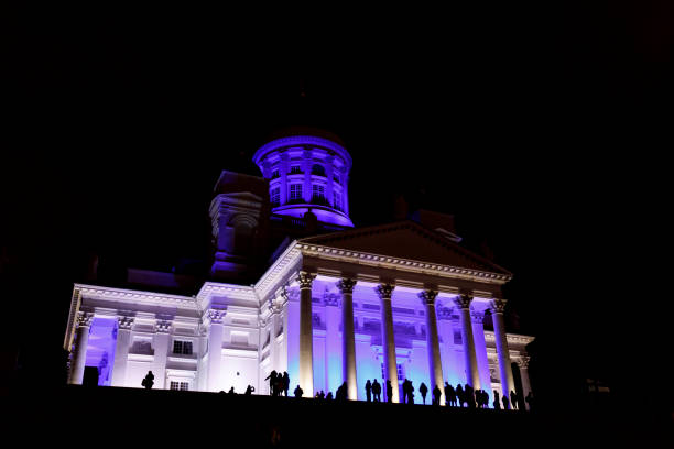 istock People stant in front of illuminated Helsinki St Nicholas cathed 897584220