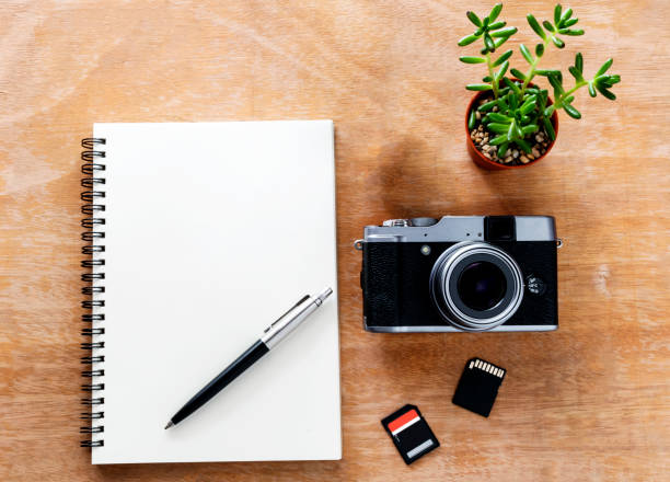 istock Top view The desks with notebooks, pens, cameras and memory cards. 897593604