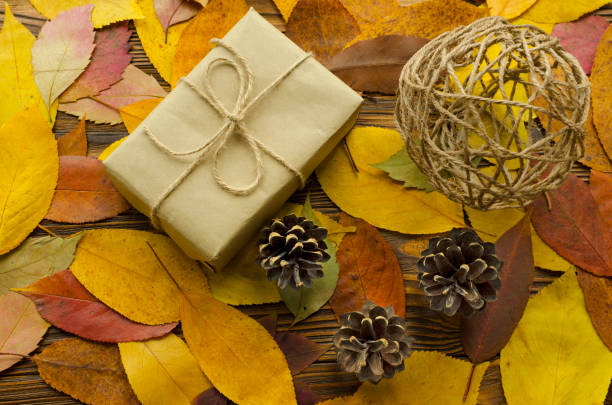 istock Gift box on colored autumn leaves background 897594862