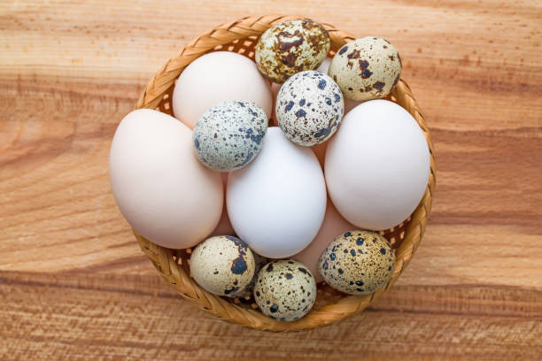istock Raw quail and chicken eggs in a wicker vase 897613560