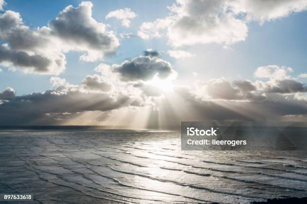 Clouds And Sunbeams Over The Coast Near Saunton Sands Beach On The Coast Of North Devon England Stock Photo - Download Image Now