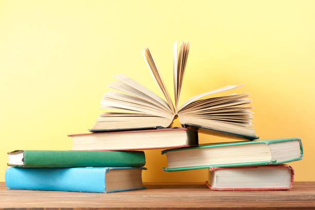istock Open book, hardback books on wooden table. Education background. Back to school. Copy space for text. 897638884