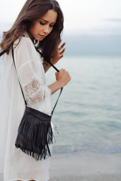 istock beautiful young girl with a handbag 897639296