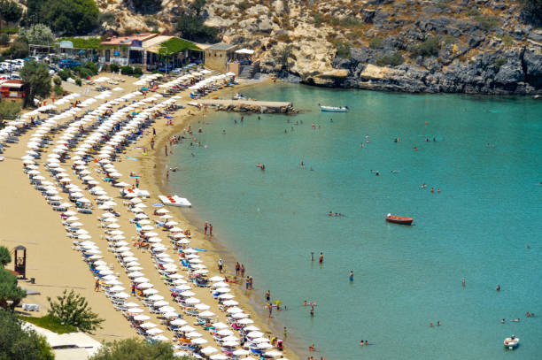 istock Beachgoers enjoy beautiful Lindos Beach in Rhodes, Greece 897646852