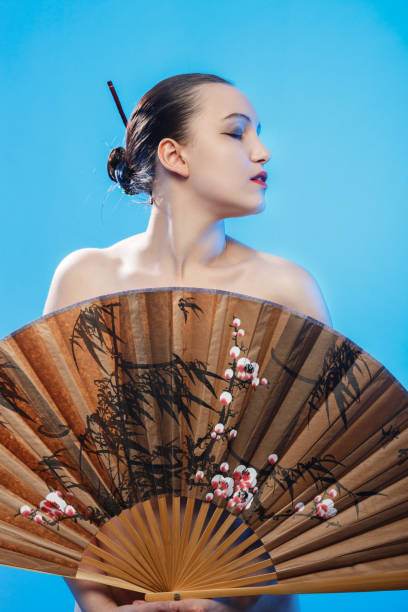 istock woman with fan 897647194