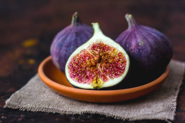 istock Fig fruits on clay plate on dark background. 897660968