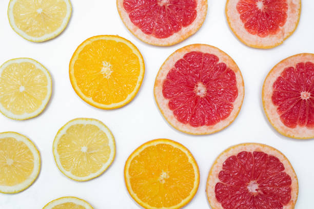 istock slices of oranges, lemons and grapefruits on vintage white table. Citrus fruit background. healthy eating with natural vitamins. Top view 897661238