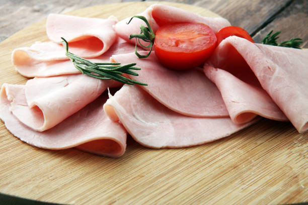 istock Sliced ham on wooden background. Fresh prosciutto. Pork ham sliced. 897662194