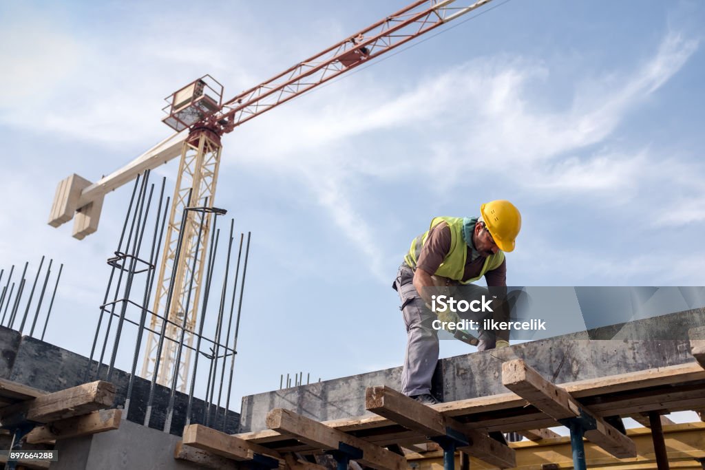 Worker At Construction Site Is Fixing The Form For The Beam Construction Site Stock Photo