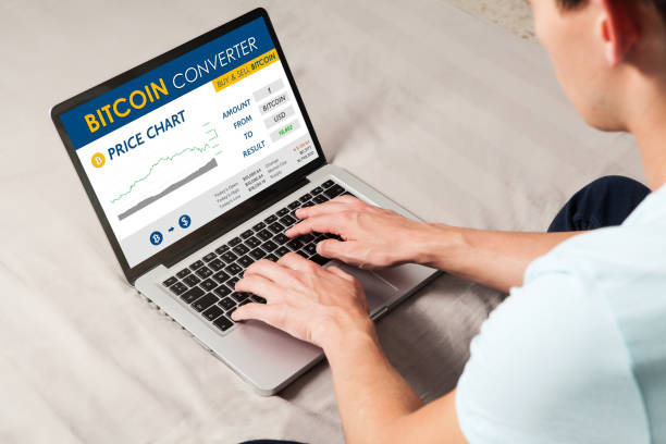 istock Bitcoin trading website. Man using a laptop to trade bitcoin price by internet. 897664748