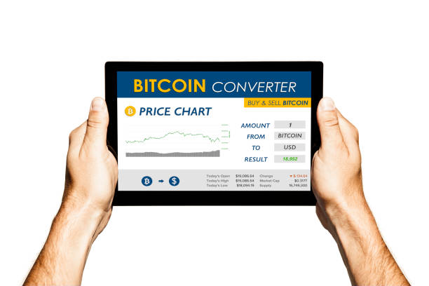 istock Bitcoin converter website in a tablet screen. Hands holding tablet with white background. 897664878