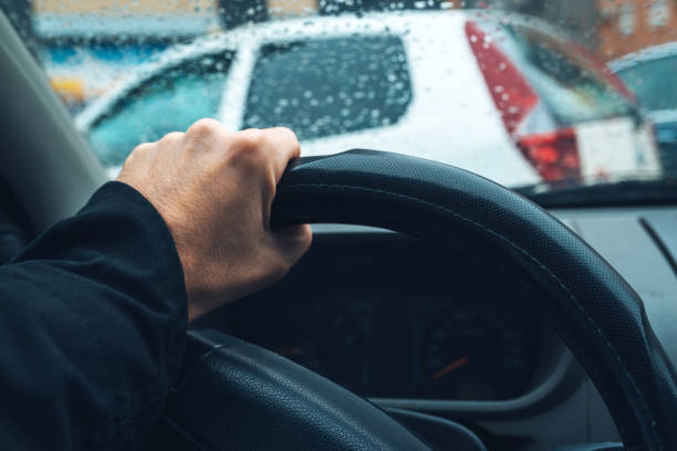 istock Male hand on car steering wheel 897668506